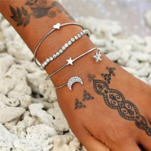 Heart Star Moon Charm Bracelet for Women and Girls - Delicate and Meaningful Jewelry on a model's wrist