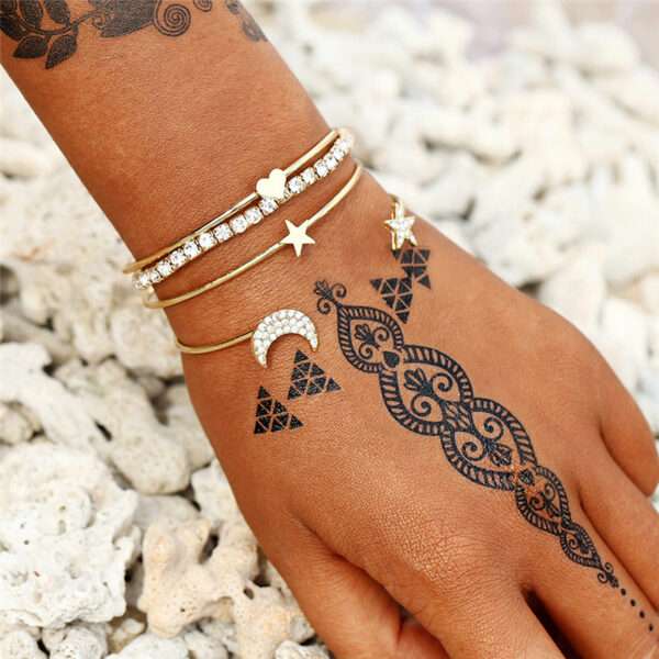 Heart Star Moon Charm Bracelet for Women and Girls - Delicate and Meaningful Jewelry on a model's wrist