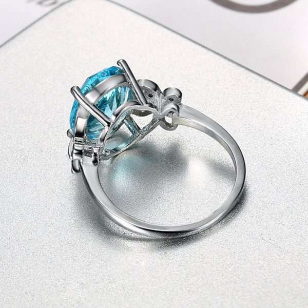 Sea Blue Sapphire CZ Finger Twist Infinity Ring - Couple Ring with Timeless Elegance on a couple's fingers