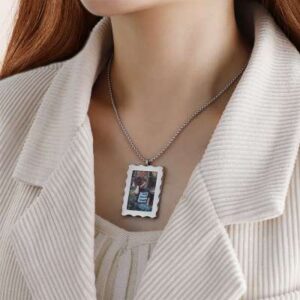 A close-up image of a personalized custom photo locket necklace. The locket pendant is beautifully designed, allowing for the insertion of a cherished photo